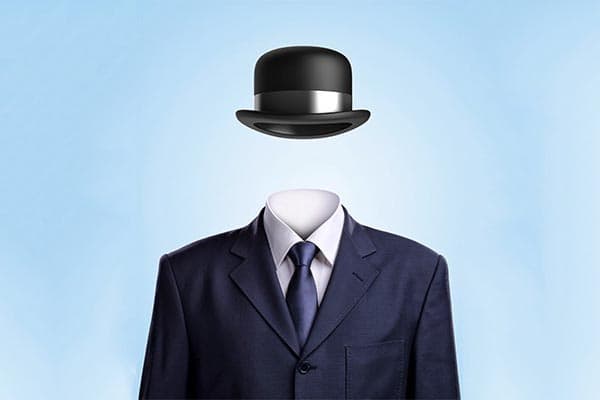 A hat floats above a suit as if on a man's head but no one is there.